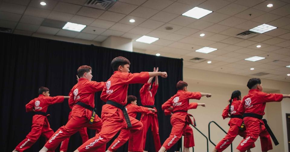 Victory demonstration team in red uniforms performing on stage